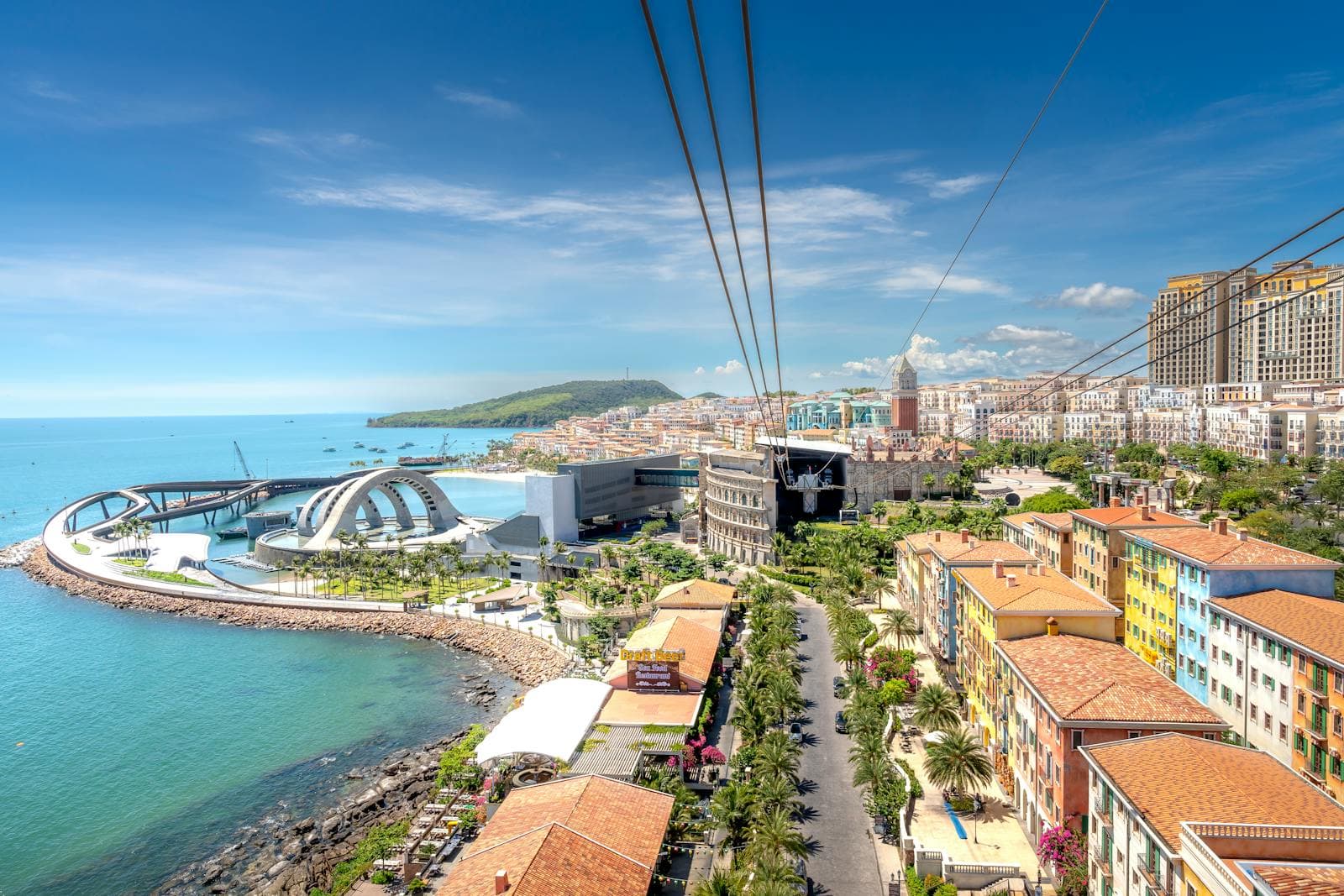 Vibrant coastal cityscape featuring modern architecture and blue seashore.