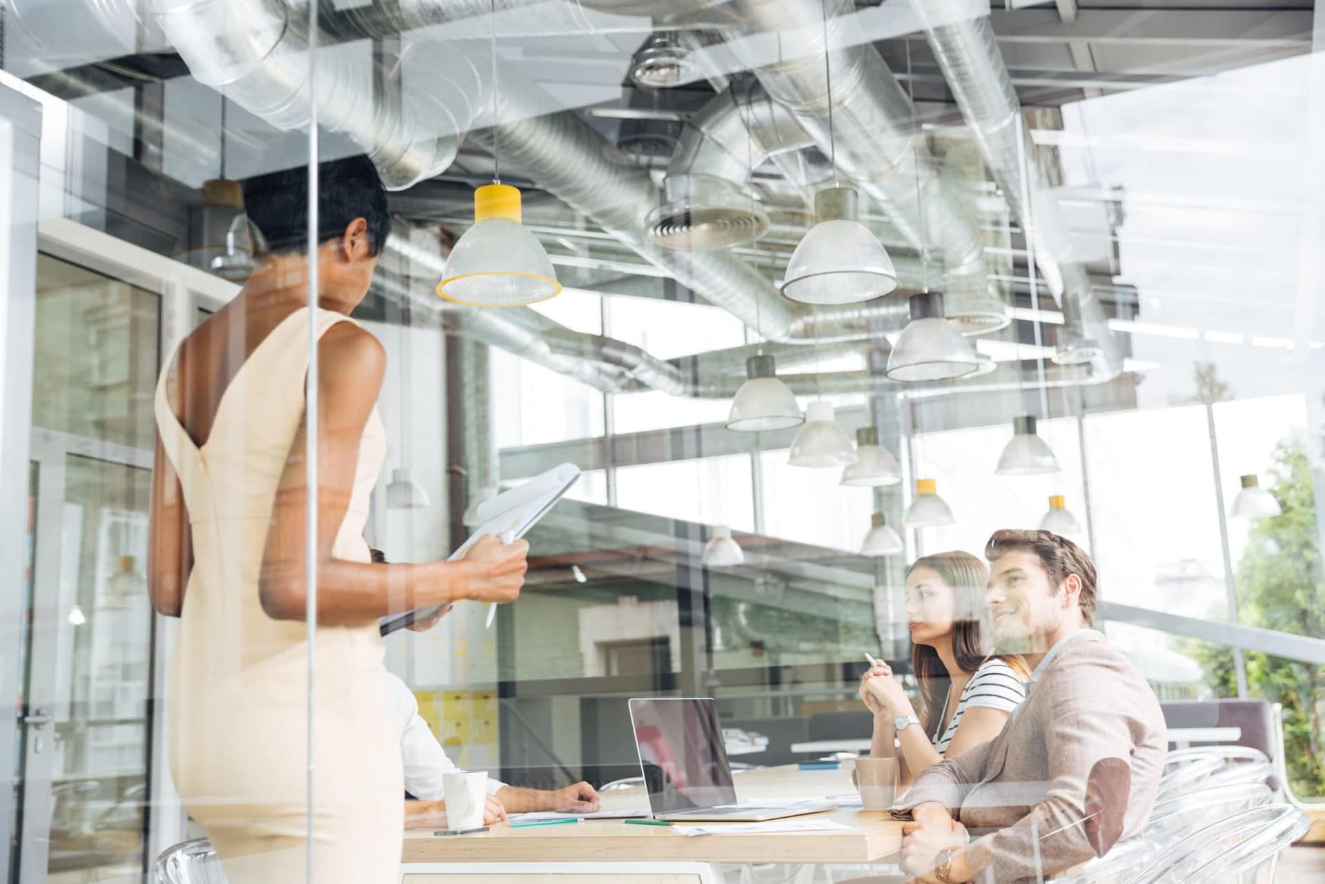 Businesswoman standing and making resentation in modern office
