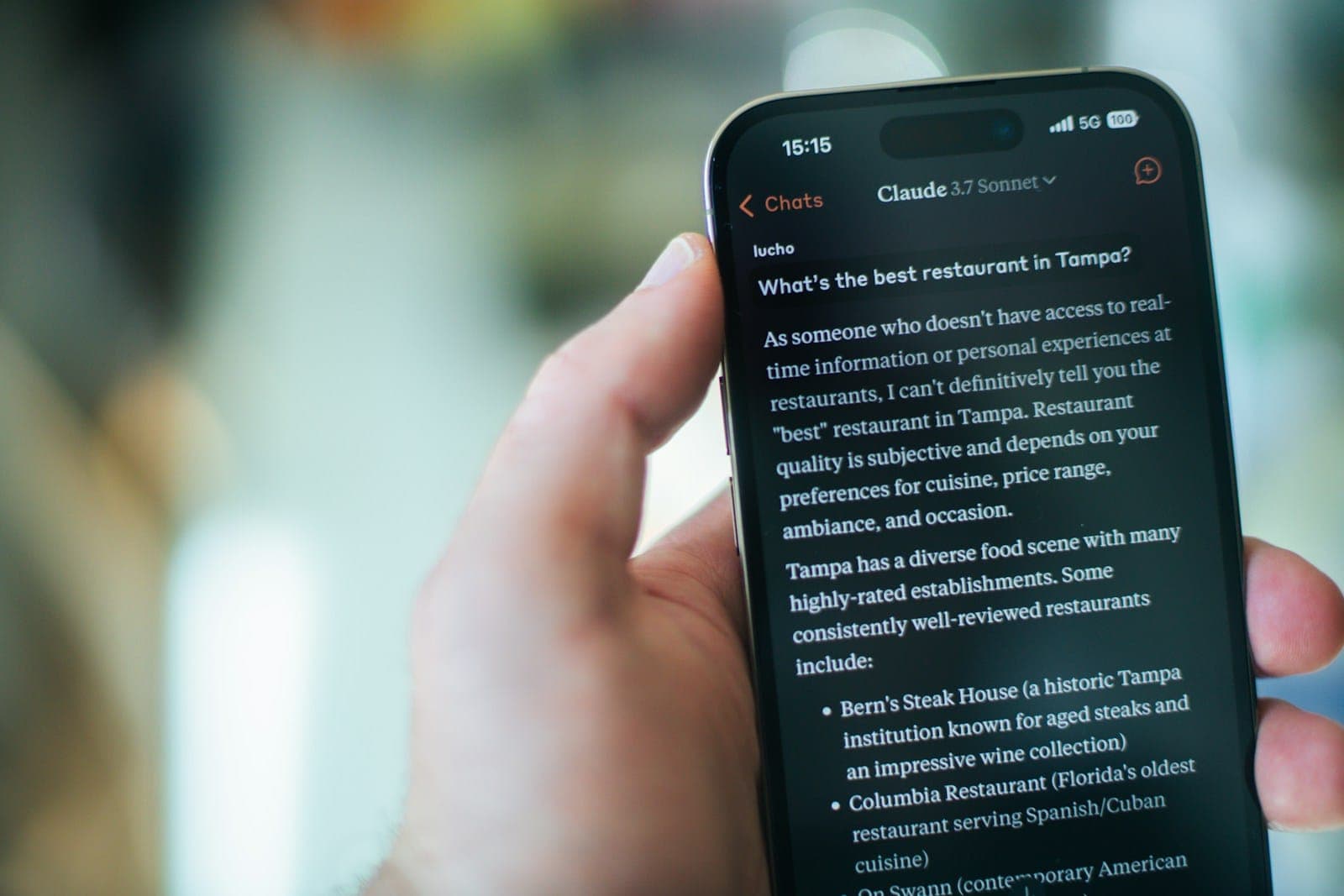 A person reads restaurant recommendations on their phone.