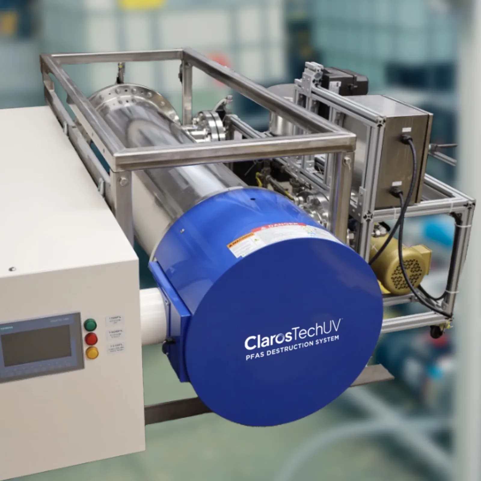 The ClarosTechUV PFAS destruction system, an industrial treatment skid with a cylindrical ultraviolet reaction chamber and a control cabinet.
