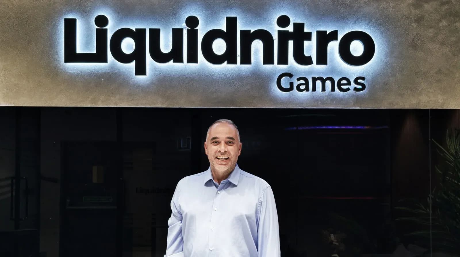 Cedrick Collomb, new chief technology officer of Liquidnitro Games, standing outside the studio's Hyderabad office beneath the company sign