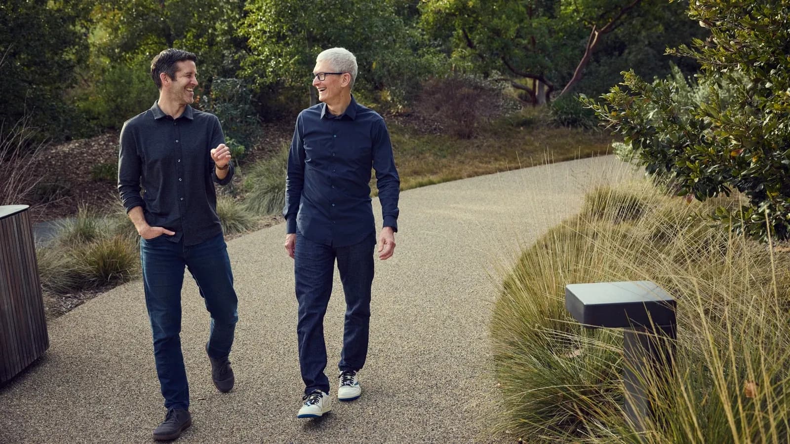 Tim Cook and John Ternus walking together at Apple Park on the day of the CEO succession announcement