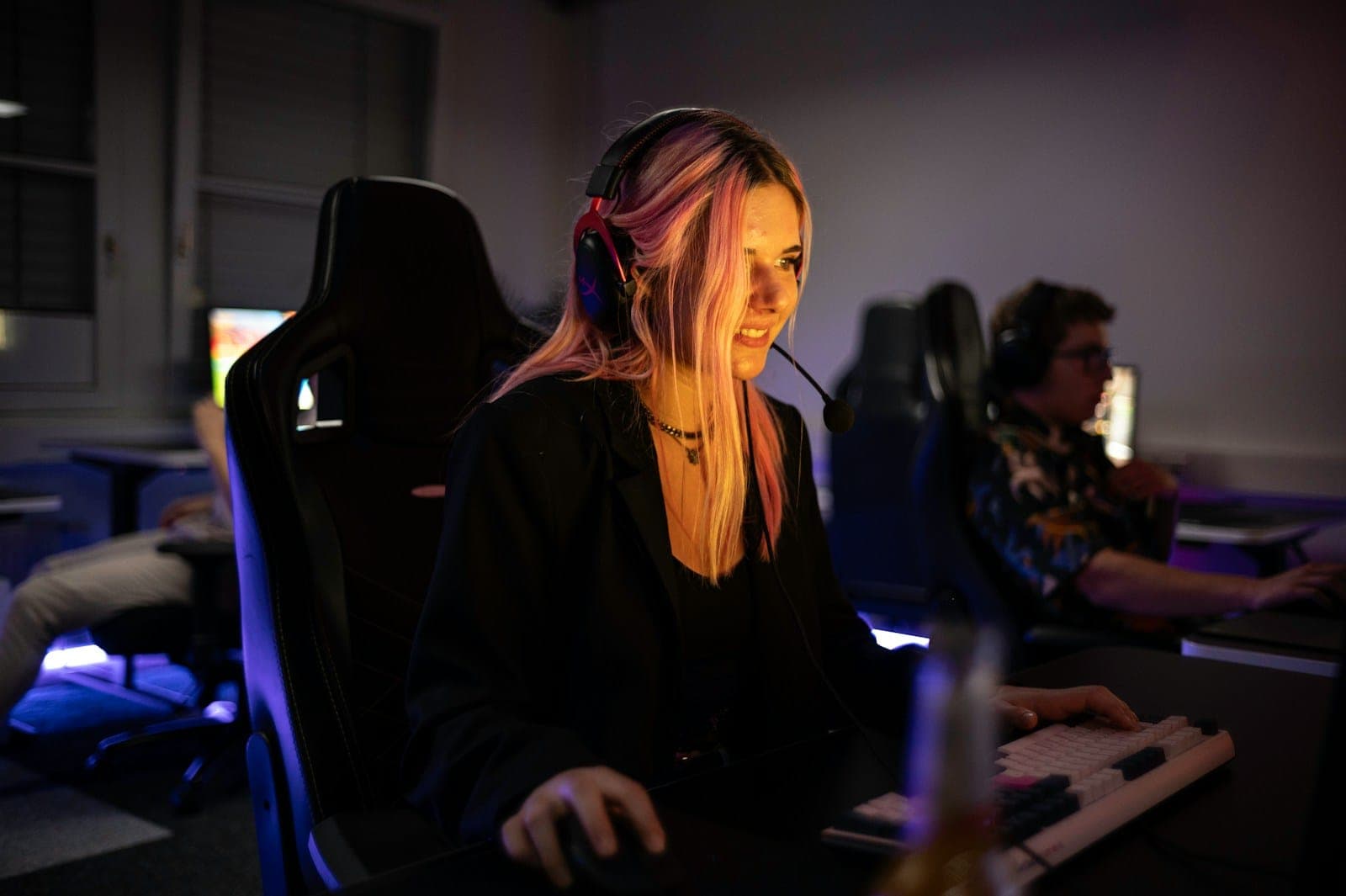A woman sitting at a desk with headphones on