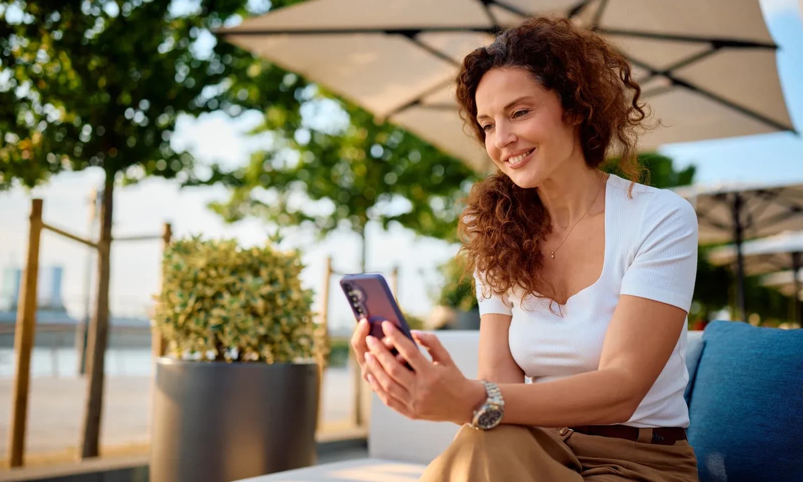 Hospitality professional using social media on a hotel terrace