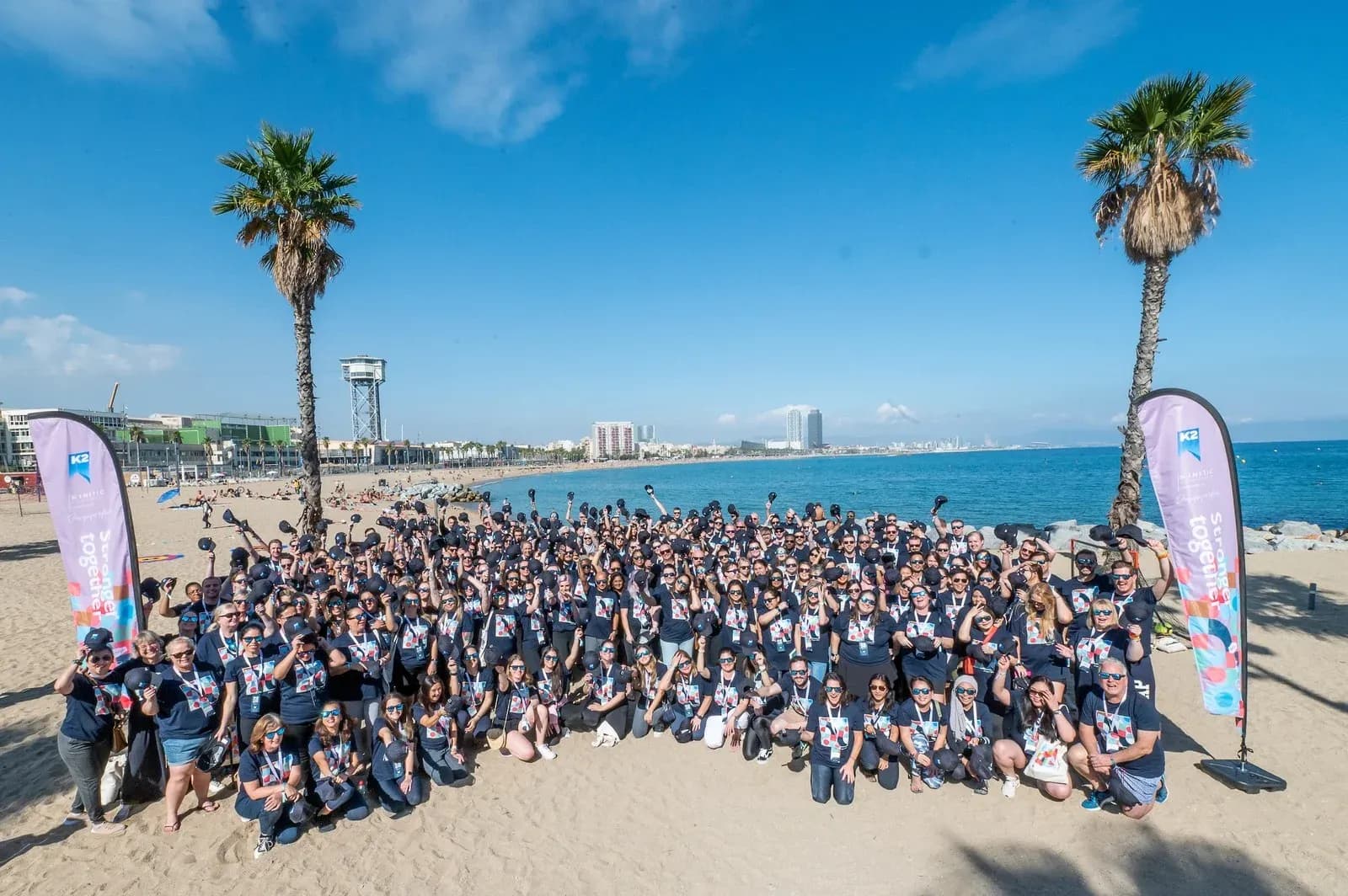 K2 Group team photo on a beach