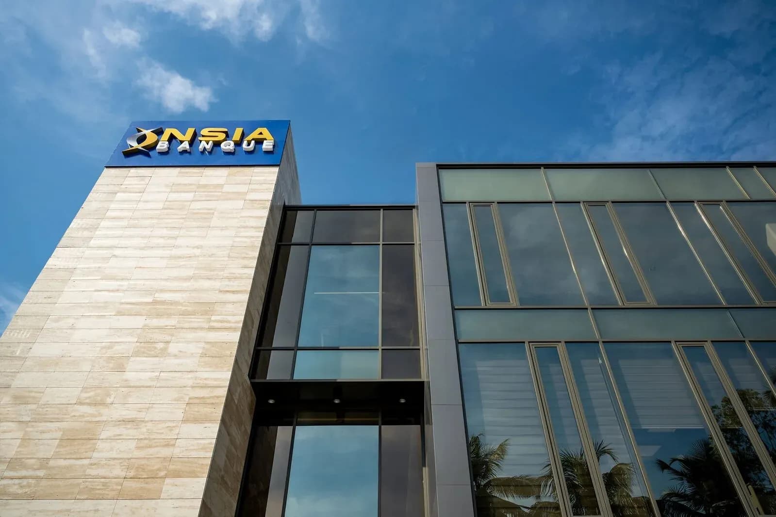 Exterior of an NSIA Banque branch in Côte d'Ivoire, with the bank sign above a glass facade