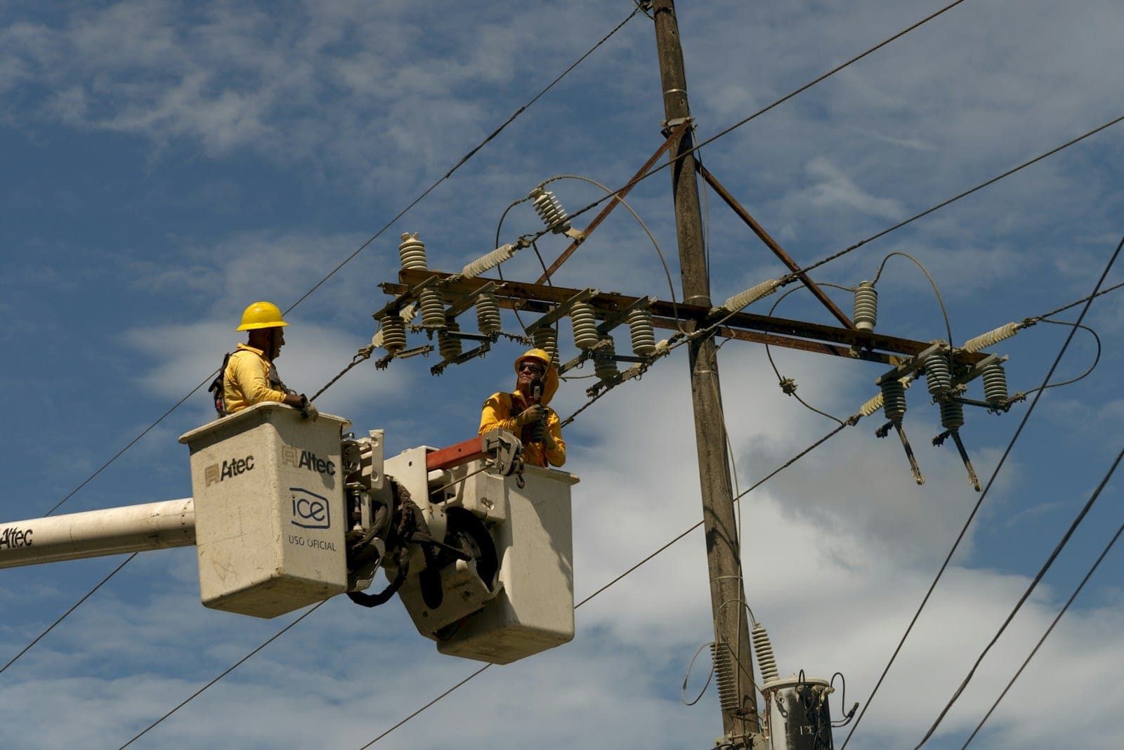 A couple of men working on a power line