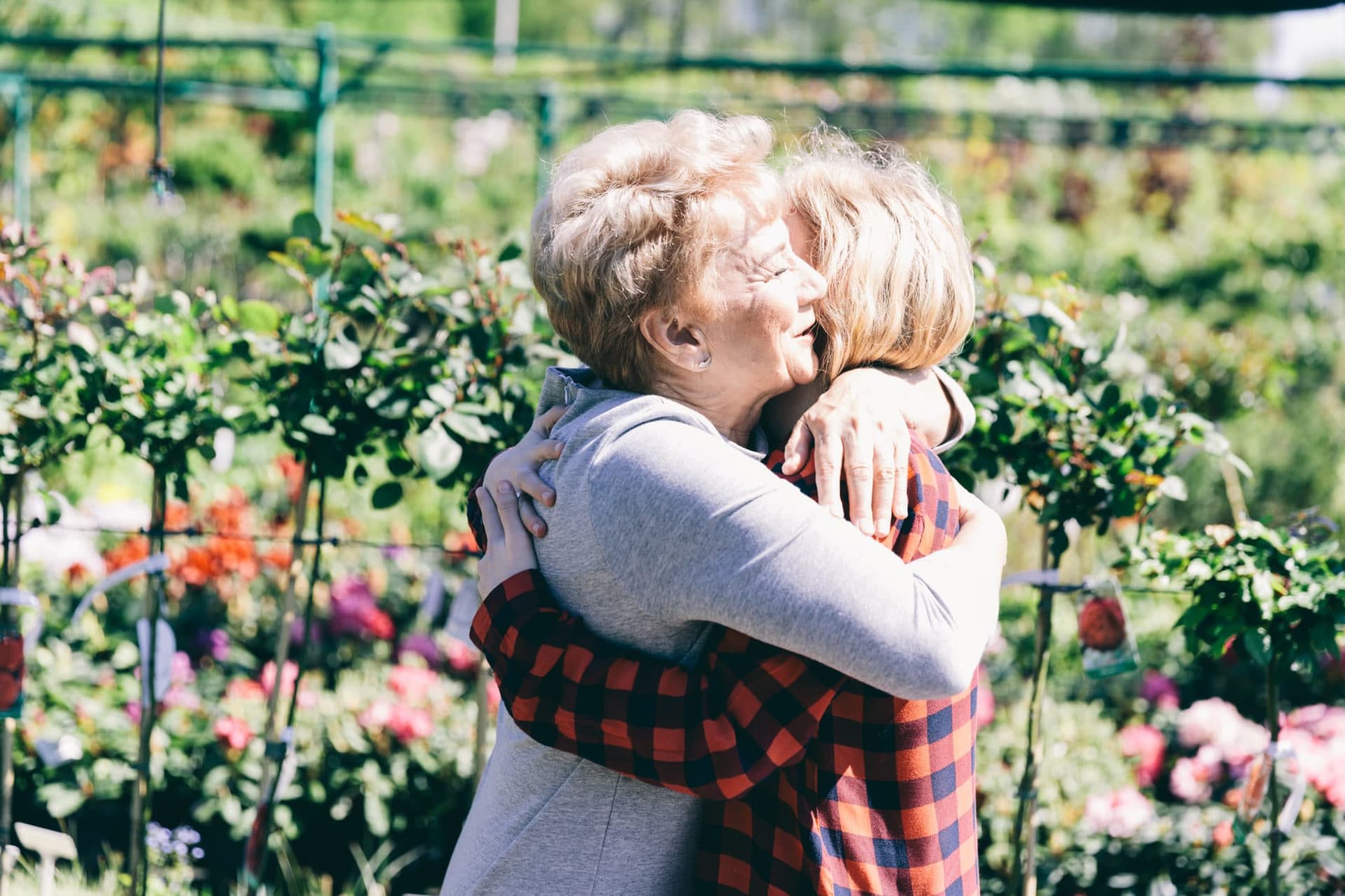 Older lady hugging her granddaughter