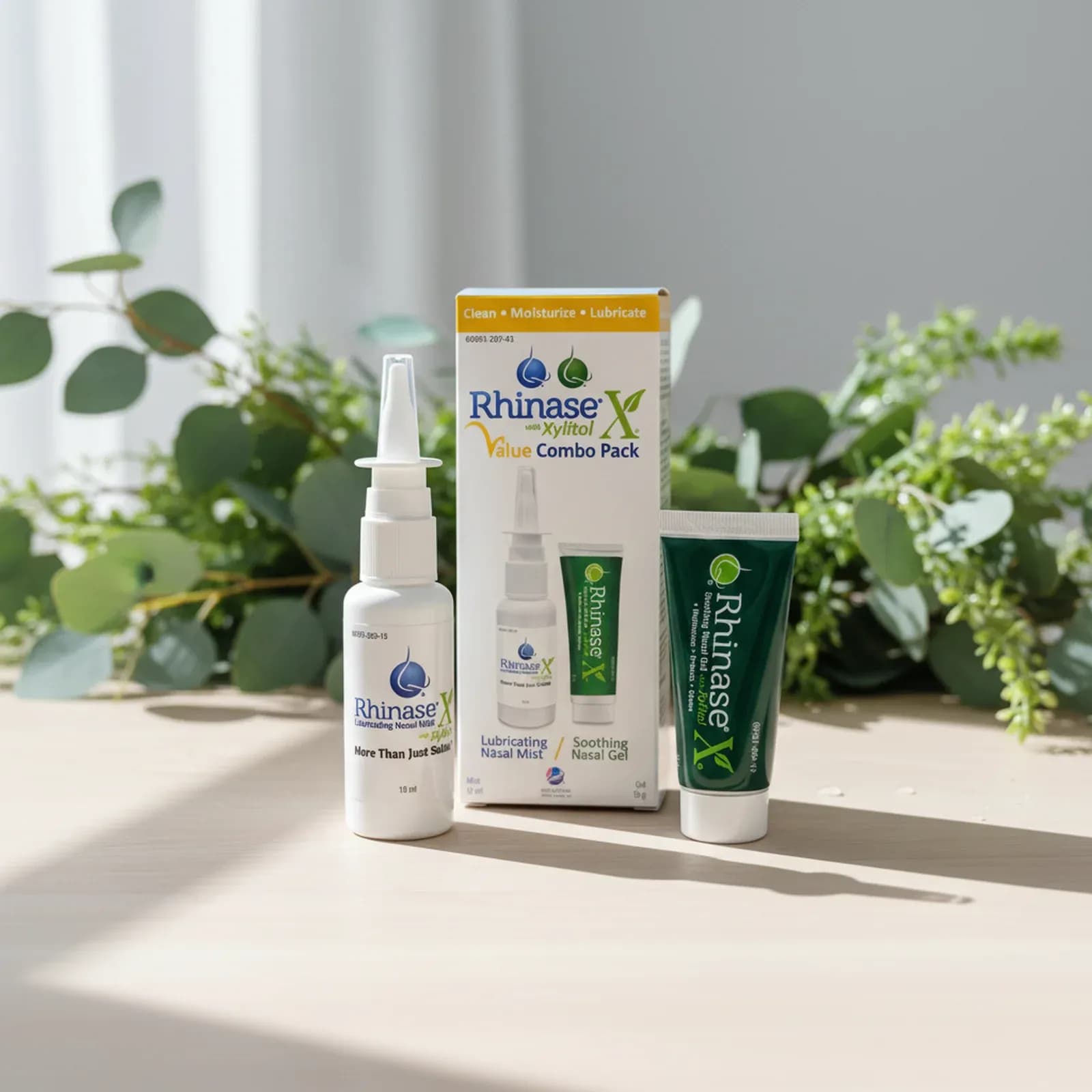 Rhinase X Value Combo Pack nasal spray and gel on a wooden table with eucalyptus leaves