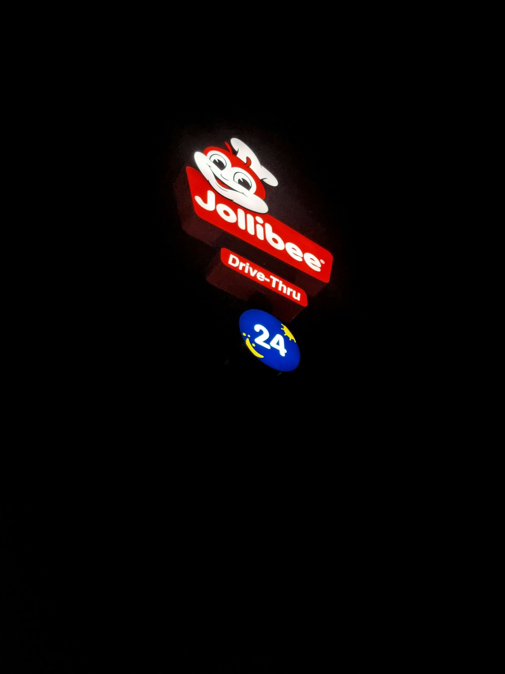 a neon sign is lit up in the dark