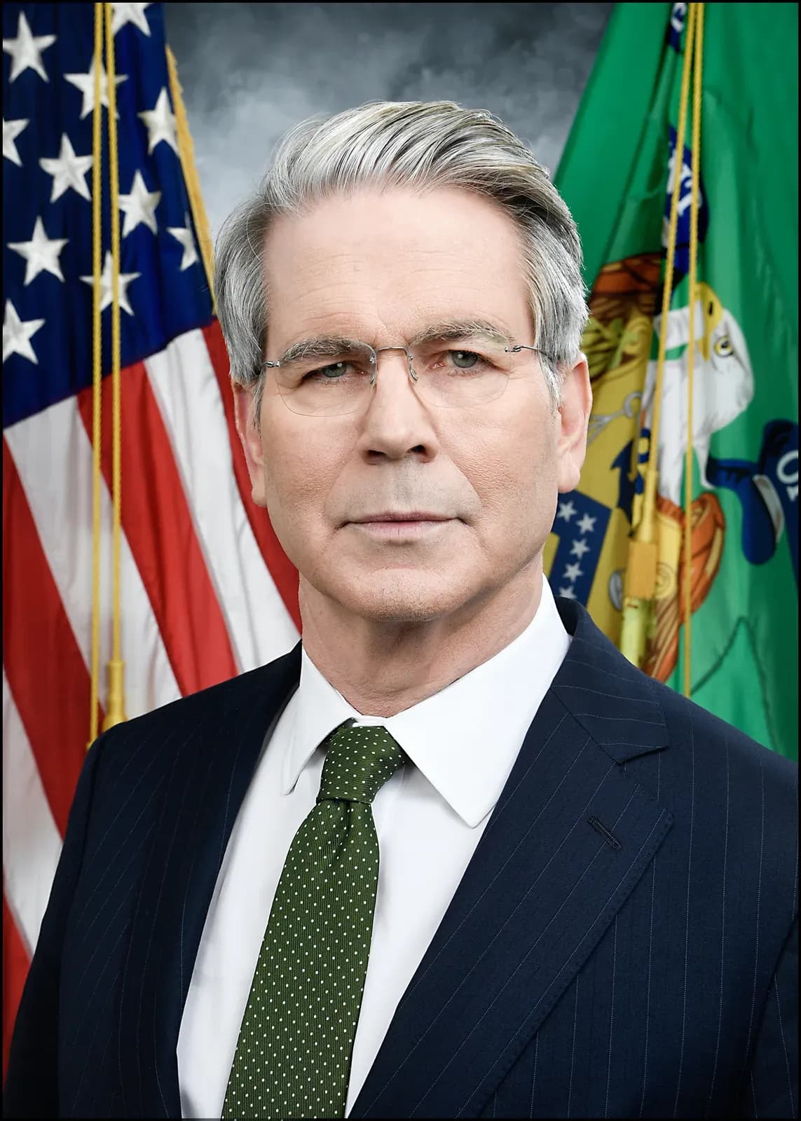 Treasury Secretary Scott Bessent in a formal portrait, with the United States flag and the Treasury Department flag behind him.