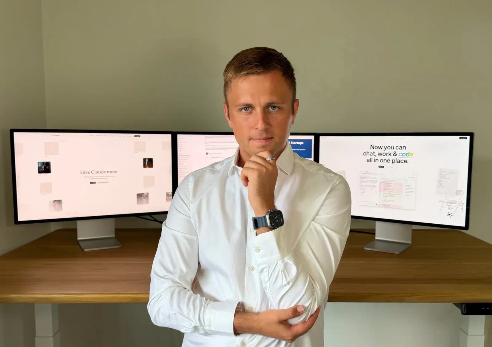 Use.ai co-founder Ihor Herasymov at his desk in front of three monitors