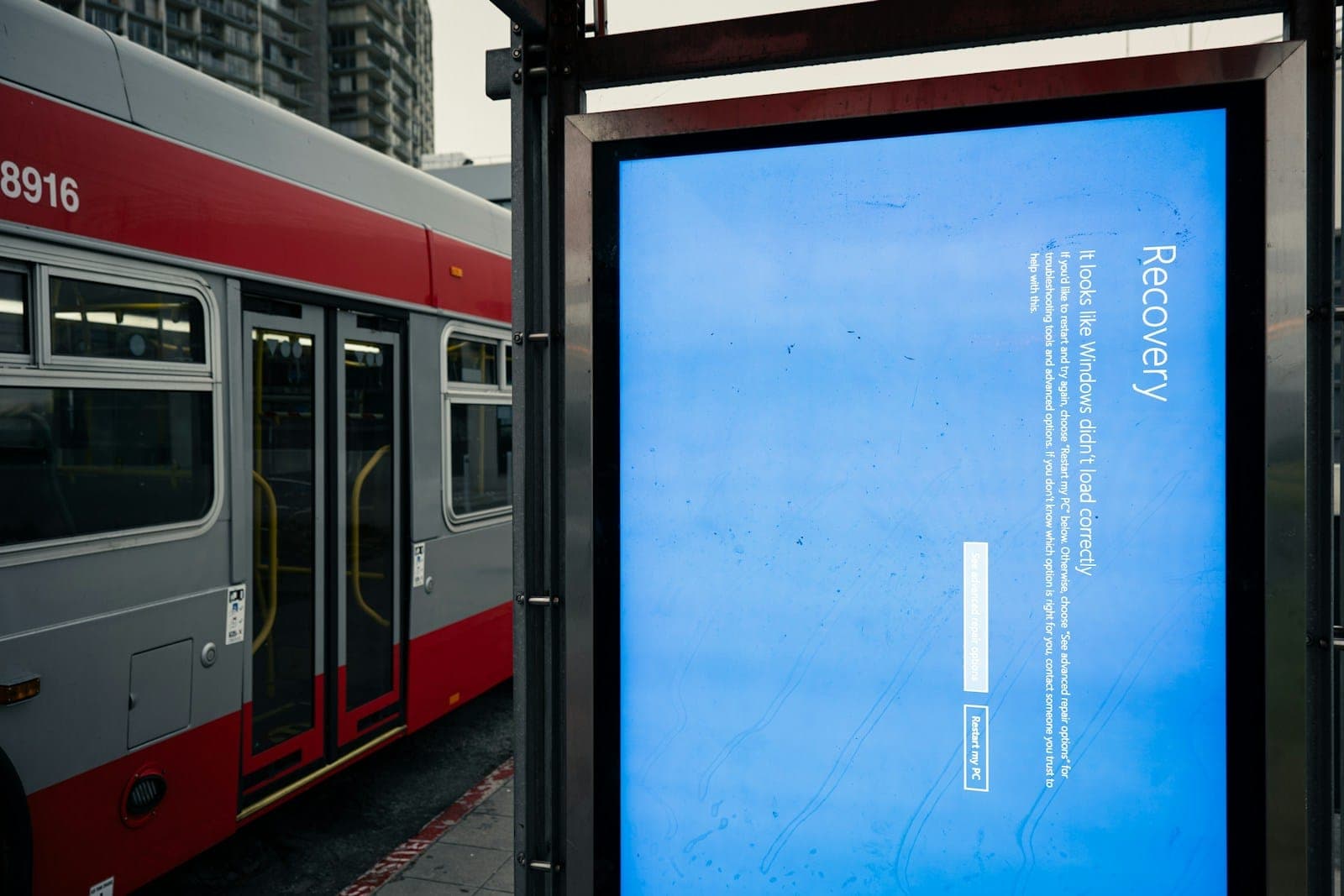 A bus stop with a bus parked next to it