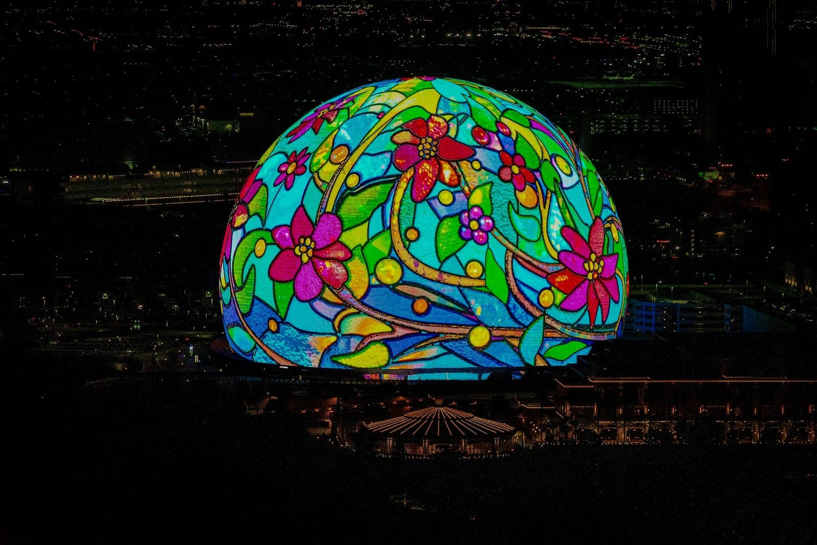 A glowing floral dome illuminated at night.