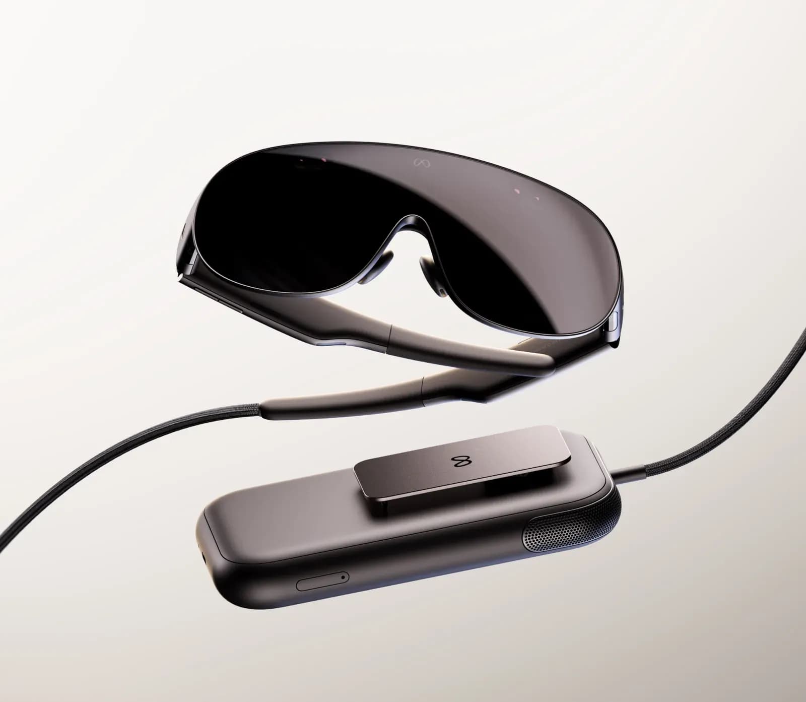 The Meta VR Glasses floating apart from their separate compute pack, connected by a thin cable, on a studio background