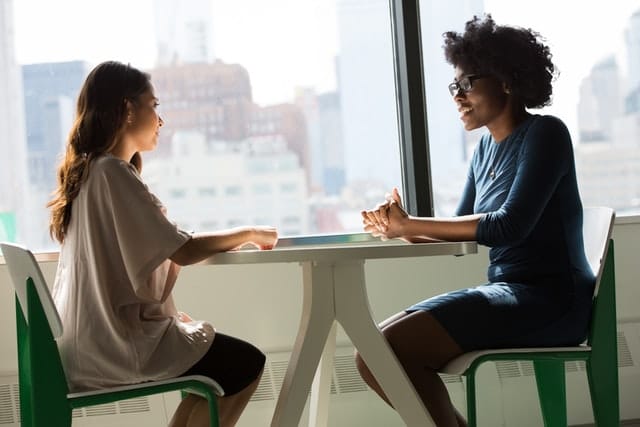 women sitting at table conducting job interview