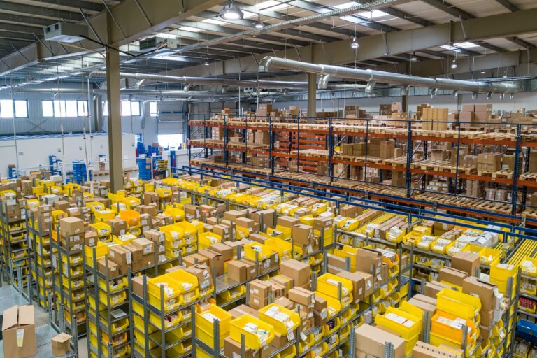 yellow and white plastic box lots neatly organised in a warehouse