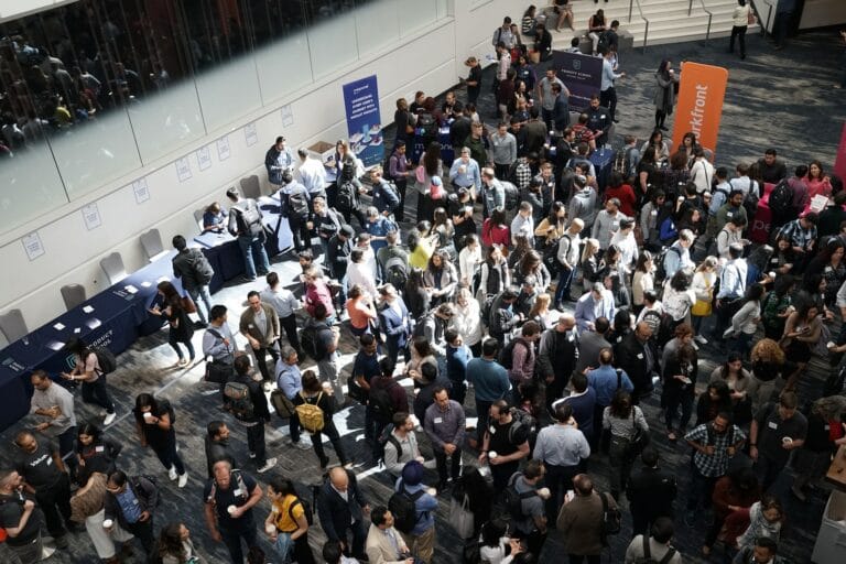 large crowd gathering at a trade show