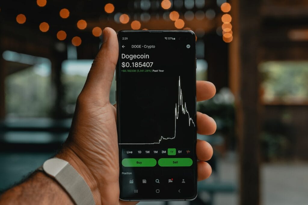 Key Concepts in Behavioural Finance Explained 2 a person holding a cell phone in their hand