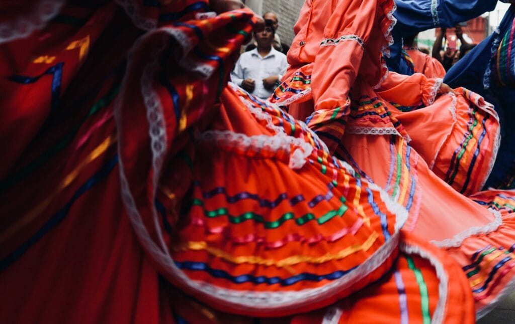 man standing behind dancers