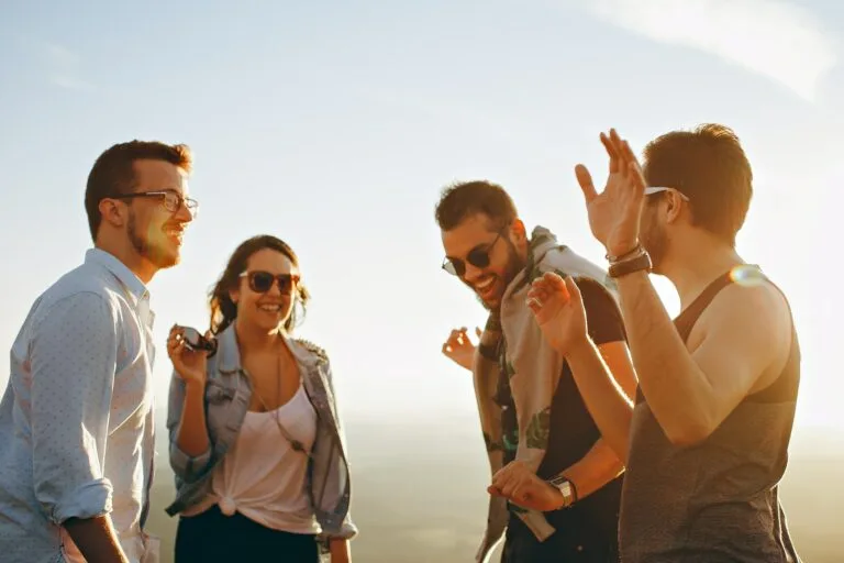 5 Steps to Elevate Employee Satisfaction in the Workplace 8 three men and one woman laughing during daytime