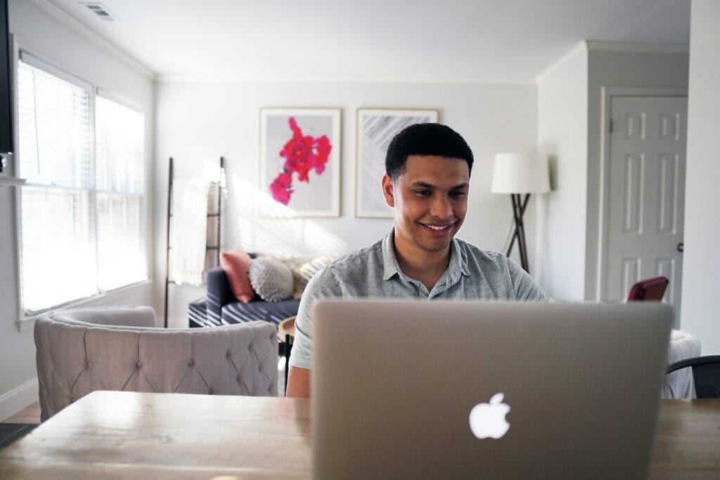 What are The Golden Rules of Investing for Beginners? 2 man in gray hoodie sitting on chair in front of silver macbook