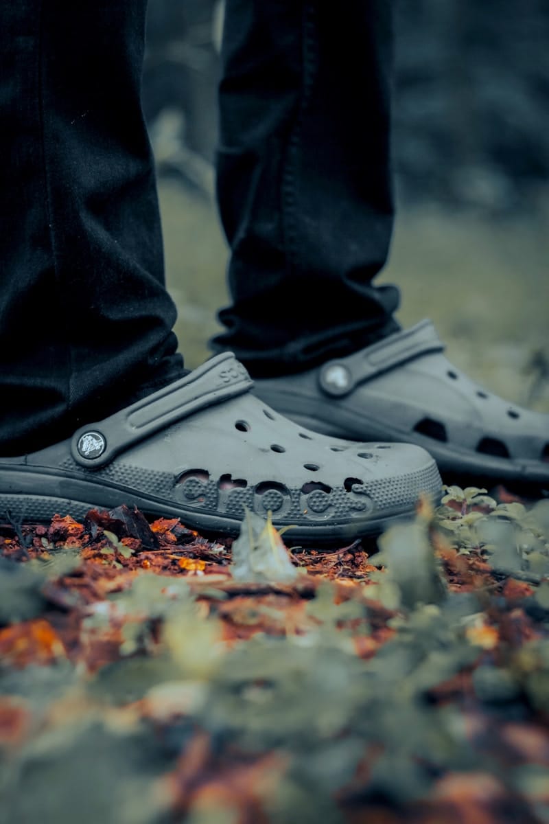 Love your Crocs? Growing Brand Loyalty Makes them the World's Number One Fashion Brand 1 person wearing black converse all star high top sneakers