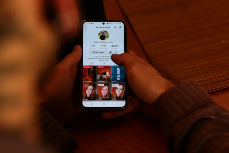 Leveraging User-Generated Content (UGC) for Shoppable Videos 1 A person holding a cell phone with multiple pictures on the screen