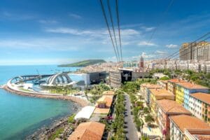 Vibrant coastal cityscape featuring modern architecture and blue seashore.