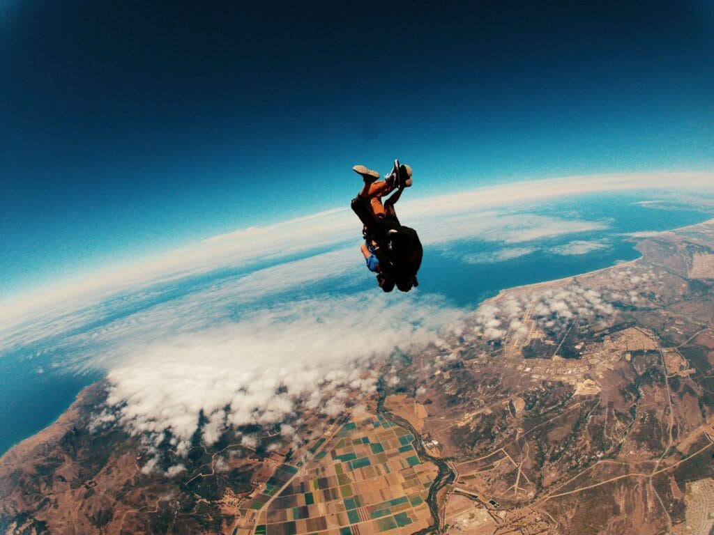 The Real Reason Your Goals Fail (And How the Smartest Leaders Engineer Gravity in 5 Moves) 2 person skydiving on air during daytime