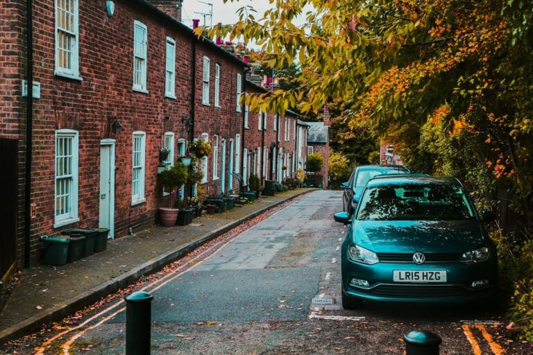 Housing Market Stability Emerges as Foreclosure Activity Returns to Pre-Pandemic Levels 1 cars parked beside the road near trees and buildings