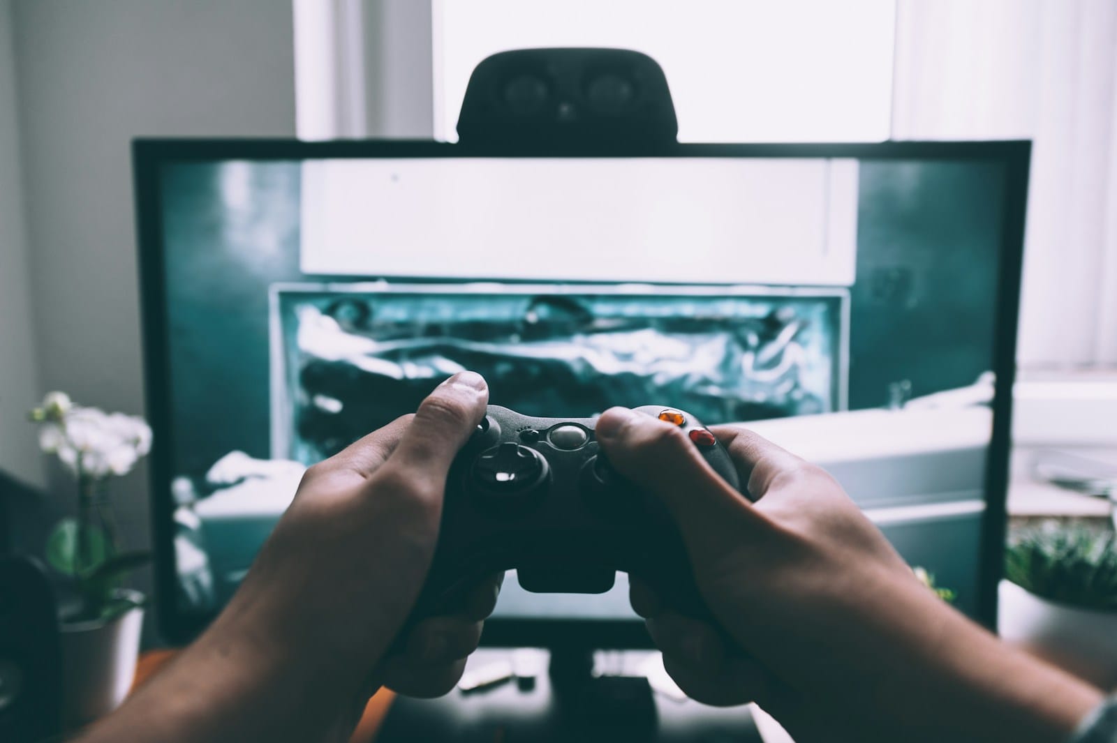 AI game-creation platforms signal new phase in developer democratisation 1 person holding game controller in-front of television