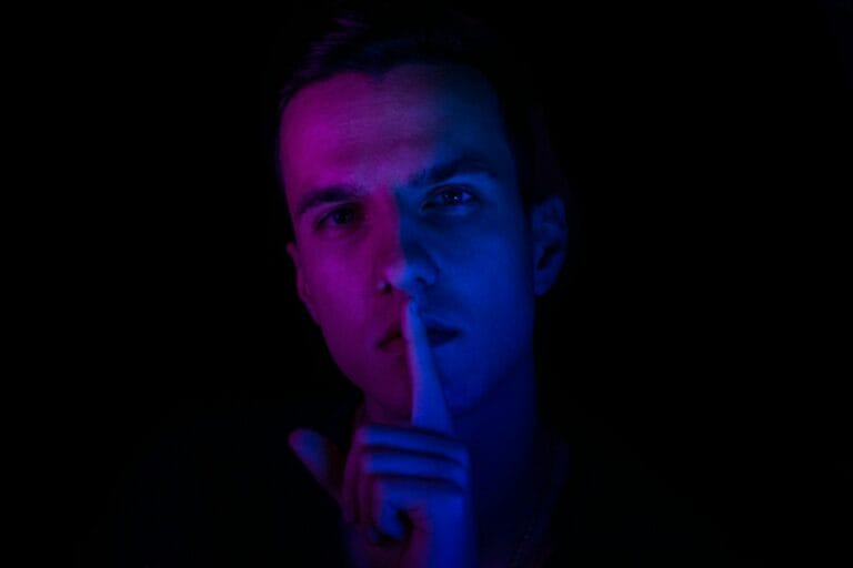 Whistleblower Protection Drives Record-Breaking Financial Sector Accountability 10 man putting his finger front of his lips