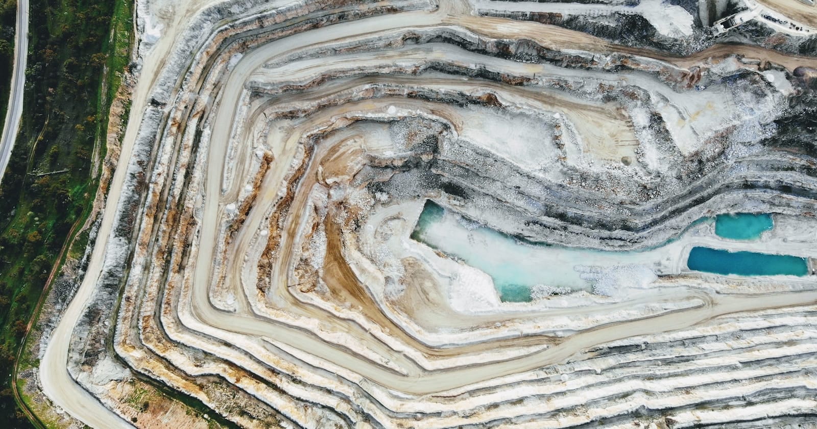Global Rare Earth Supply Chain Shifts as Major New Deposit Emerges in Central Asia 1 an aerial view of a quarry with a blue pool