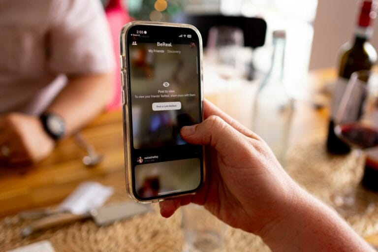 Personal AI Platforms Reshape Social Media Market Dynamics 8 a person holding a cell phone in their hand