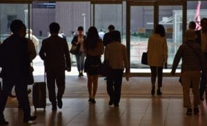 a group of people walking through a lobby