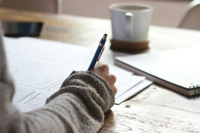 How 'Pay After You Pass' Model is Rewriting Skills Validation in Automation Testing 9 person writing on brown wooden table near white ceramic mug